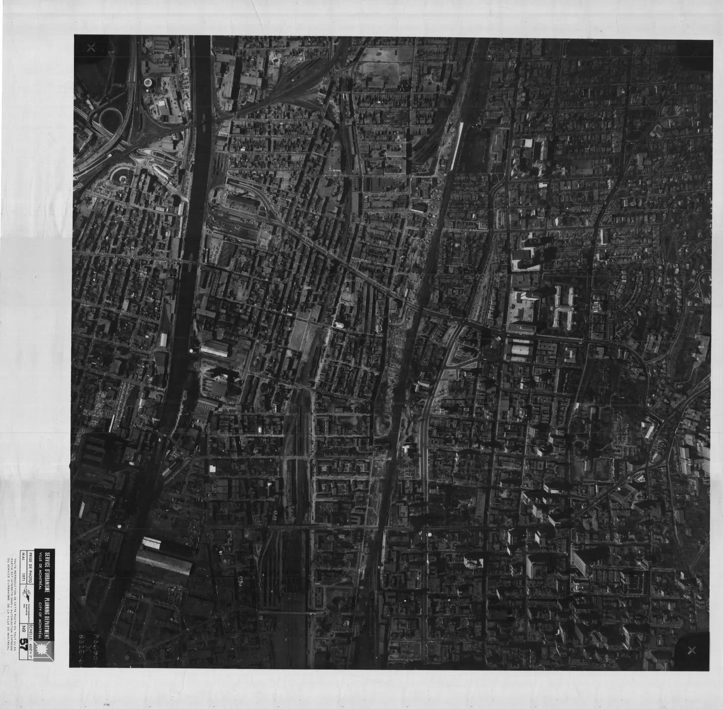 Photo noir et blanc d'une rue de Montréal bordée de bâtiments et de voitures garées